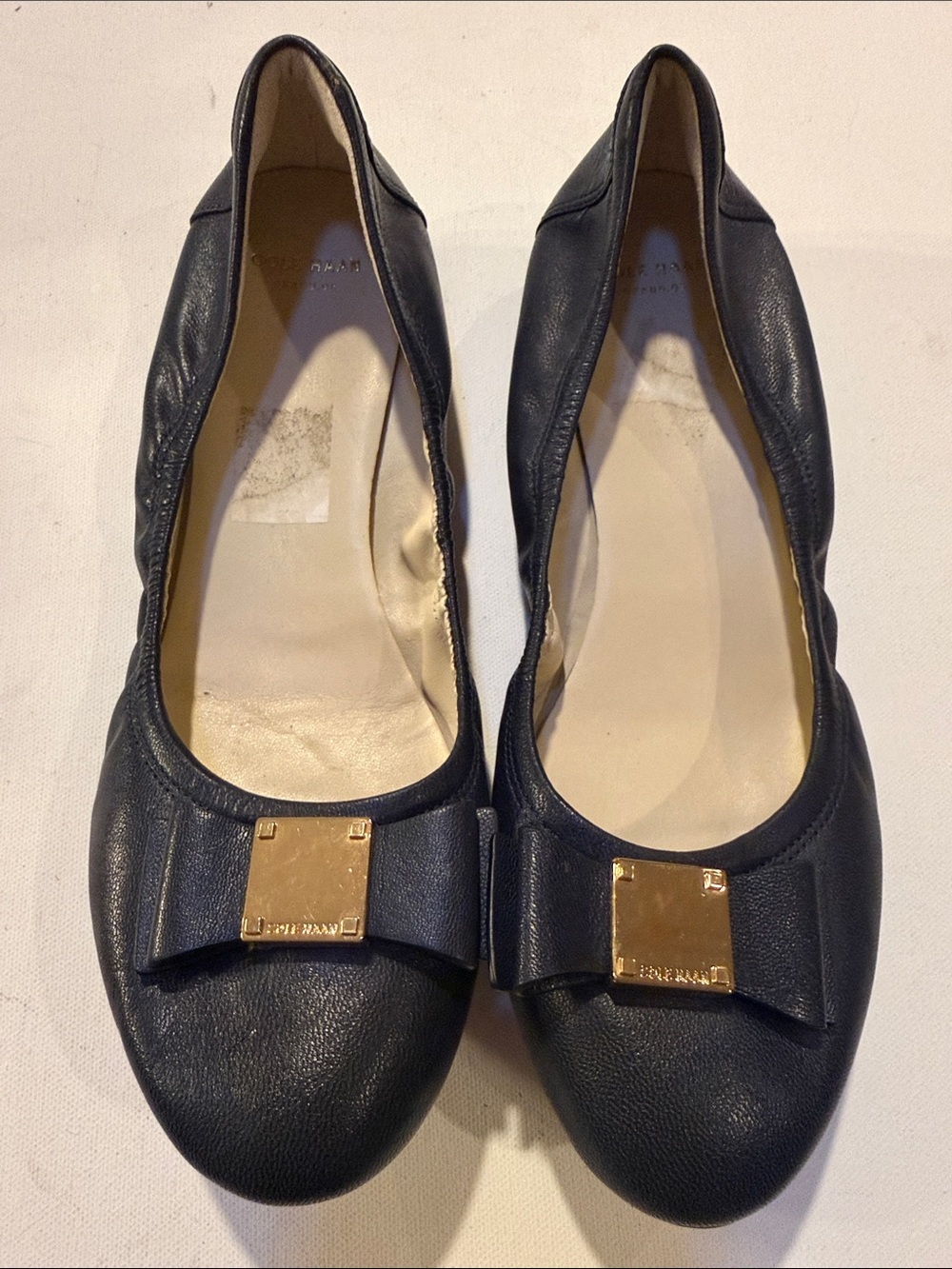 Cole Haan Black Leather Bow Flats with Gold Plaque